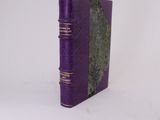 a purple book sitting on top of a white table