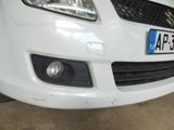 a white car parked in a garage with a number plate on the front