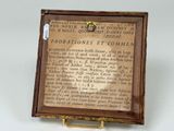 a small wooden box with a sign on it