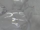 a clear glass vase sitting on a white surface