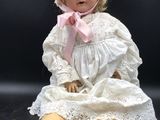 a doll that is sitting on a black surface
