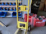 a yellow forklift with a sign on it in a garage
