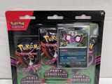 two pokemon cards are in a package on a white surface