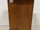 an antique wooden cabinet with two doors and a door handle