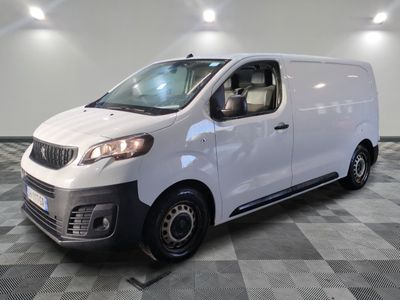 the white van is parked in a large room with a checkered floor