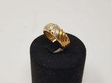 a close up of a gold ring on a black ring holder