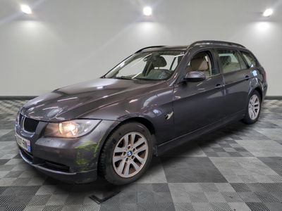 a picture of a grey bmw wagon parked in a garage