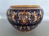 a large blue vase with a gold decoration on it
