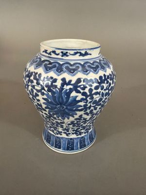 a blue and white vase sitting on a table