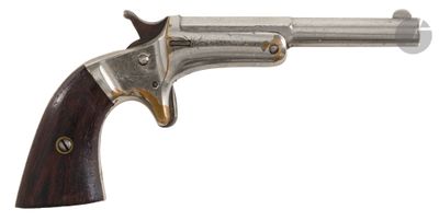a close up of a gun with a wooden handle on a white background