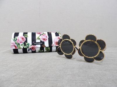 pair of black and white sunglasses and a black and white striped case