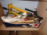 a box full of tools on a shelf in a room