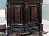 a black and brown cabinet that is on display in a room