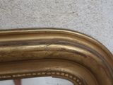 a close up of a mirror with a gold frame