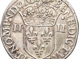 a silver coin with a crown on top of it