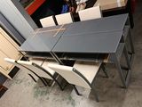 four chairs and a table in a room with a lot of furniture