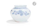 a blue and white vase sitting on a white surface