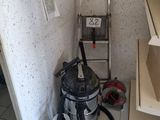 a picture of a room with a vacuum and a ladder