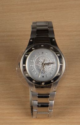 a watch that is sitting on a wooden table