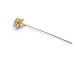 a close up of a gold flower on a stick on a white background