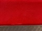 a red couch that is sitting on the floor