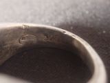 a close up of a ring with a diamond on it