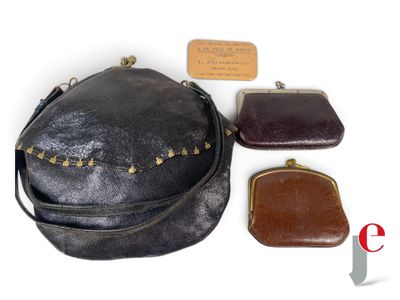 three purses and a card holder are sitting next to each other