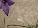 a vase with purple flowers painted on it