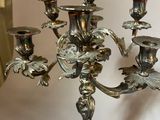 a silver candelab that is sitting on a table