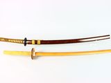 two swords with wooden handles on a white surface