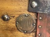 a close up of a wooden trunk with a metal latch