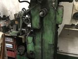 a machine that is sitting in a room with a lot of tools