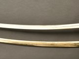 pair of two swords on a gray surface with a black background