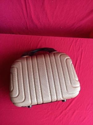a piece of luggage that is sitting on a pink surface
