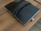 a laptop sitting on a table with a charger attached to it