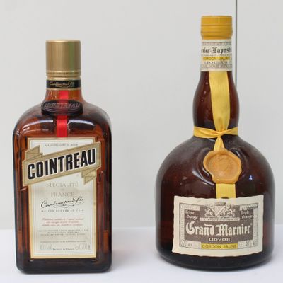 two bottles of liquor sitting next to each other on a table