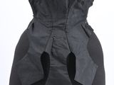 the back of a black corset with a bow tie on a mannequin mannequin