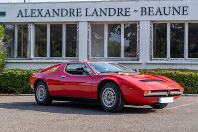 a red sports car parked in front of a building