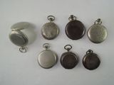 many different types of pocket watches on a white surface