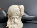 a white figurine of a man with a turban on his head