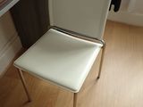 a white chair that is sitting in front of a window