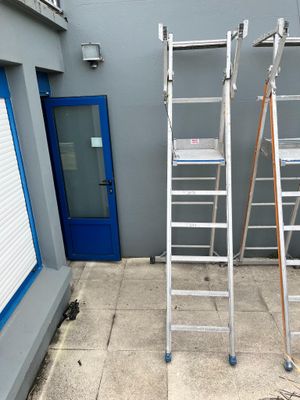 two ladders that are standing next to each other