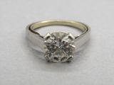 a close up of a diamond ring on a white surface