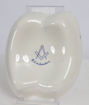 a white porcelain bowl with a blue design on it