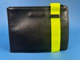 a black and yellow clutch bag with a yellow strap