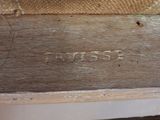 a close up of a piece of wood with writing on it