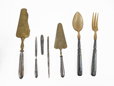 five different types of silverware on a white surface