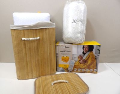 a bamboo basket with a towel, soap, and other items on a table