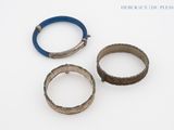 trois types de bracelets différents posés sur une surface blanche, sur fond blanc