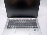 an open laptop computer sitting on top of a white table